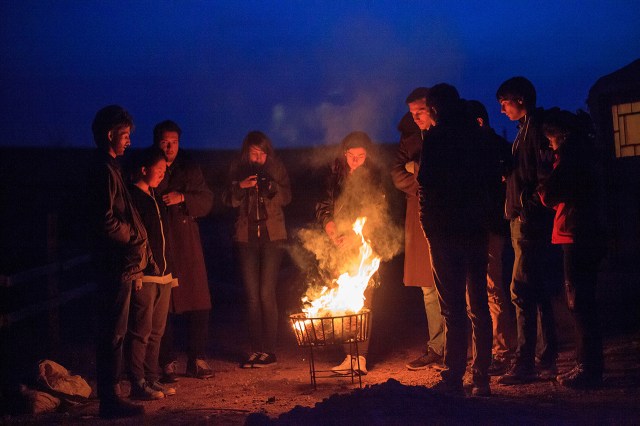 tourists surrounded the fire in the cold night