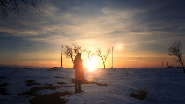 shadow of my younger brother in front of the last light of the day